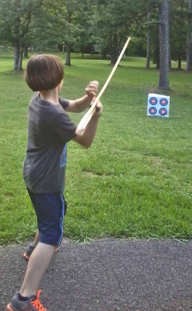 Thrower's take aim with atlatl and dart