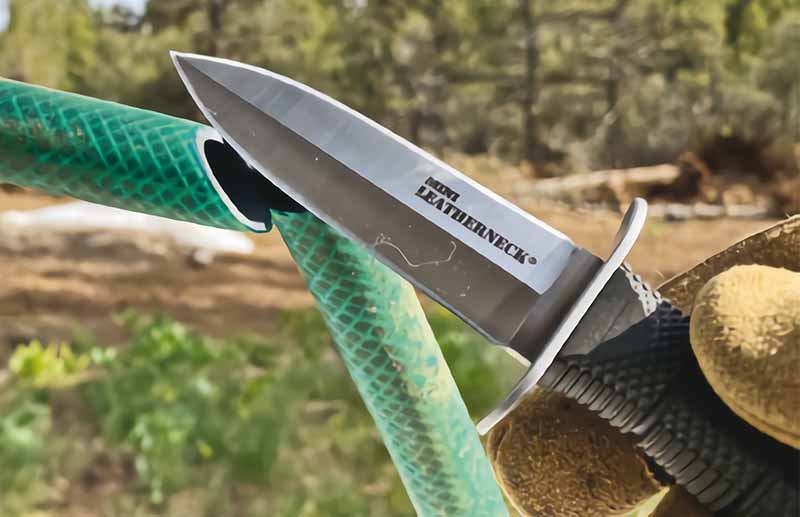 The Mini Leatherneck slices garden hose. Some daggers, due to steep blade geometries, do not cut very well. Not so this little puppy.