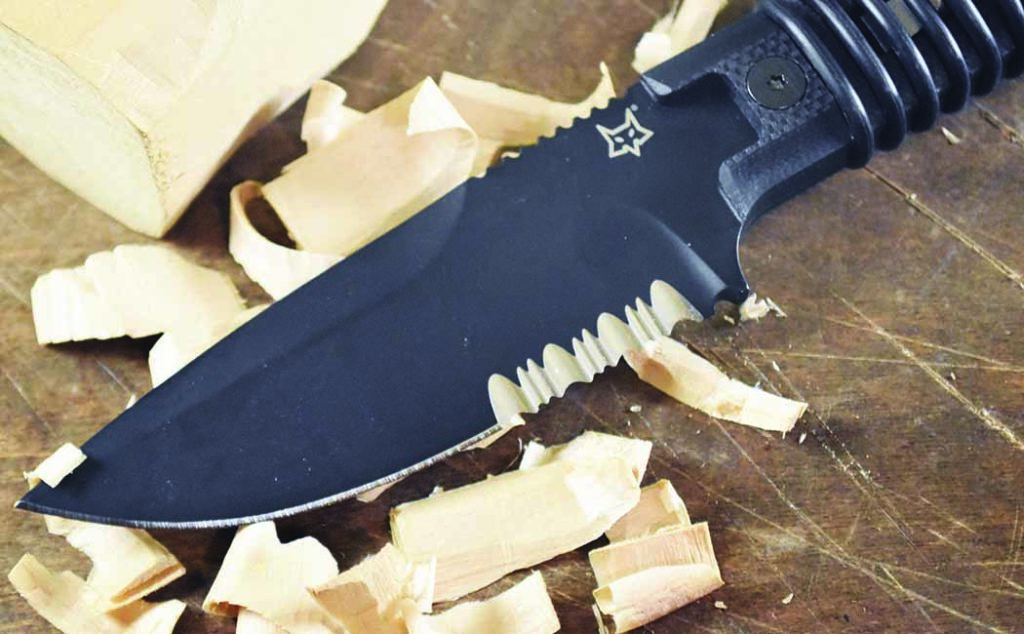 Using the plain-edge portion, the 3.54-inch Bohler N690 stainless steel blade of the Fox Knives Ferox serves up some nice shavings from a block of wood.