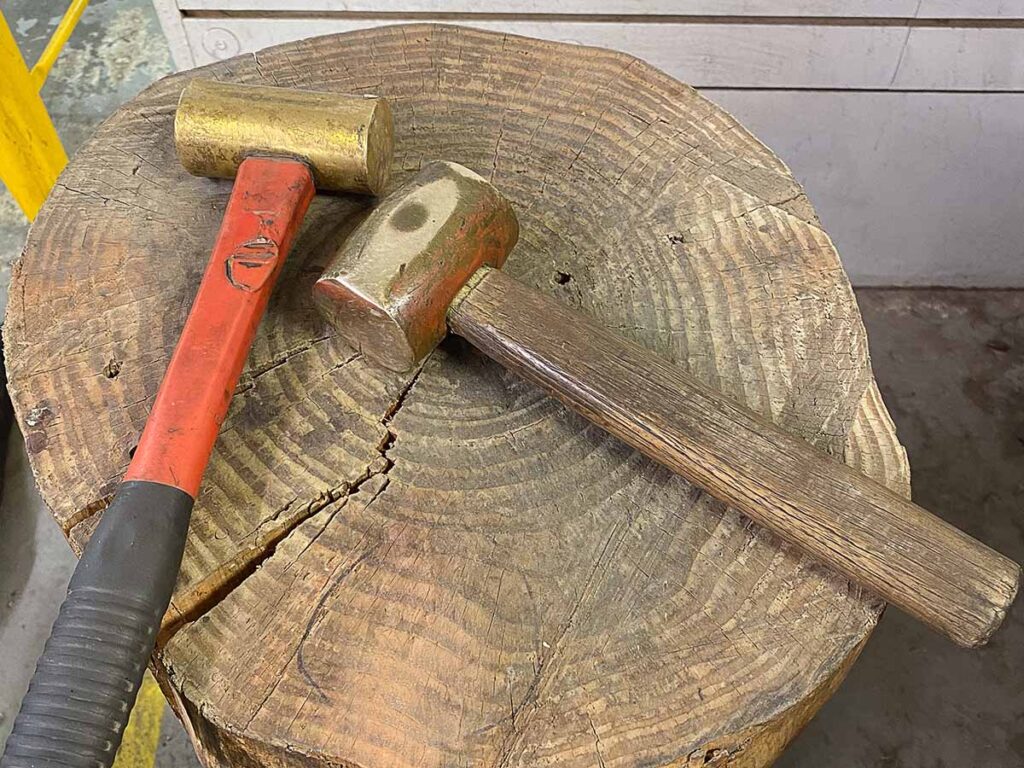 brass hammer and wood stump