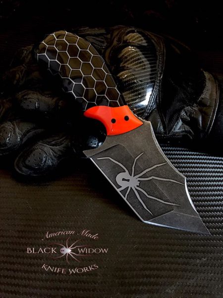 The Carnage by Brent Vacarro at Black Widow Knifeworks & Tactical Gear sports a handle made from a Black Honeycomb and Orange block made by Voodoo Resins.