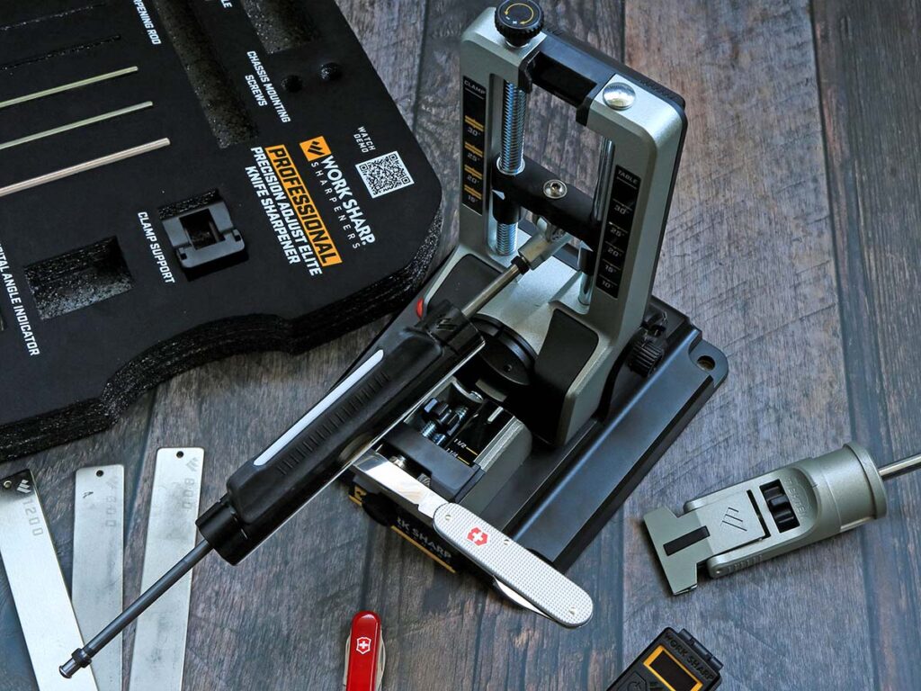 The magnet system of the Work Sharpās knife attachment helps keep smaller blades in place while a support hand helps steady them.