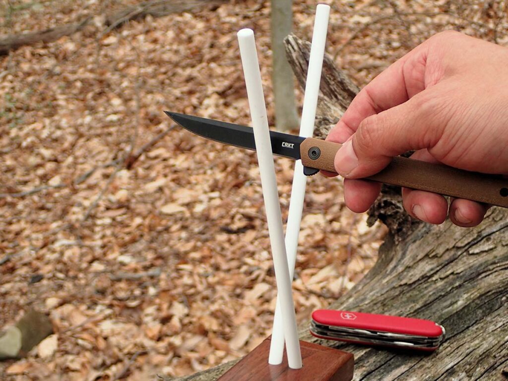 To preset the 15-degree angle with the A.G. Russell V Sharpener, start at the knife hilt and draw down steadily with moderate pressure.