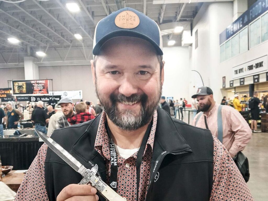 Frank Edwards displayed his heavily engraved damascus automatic dagger.