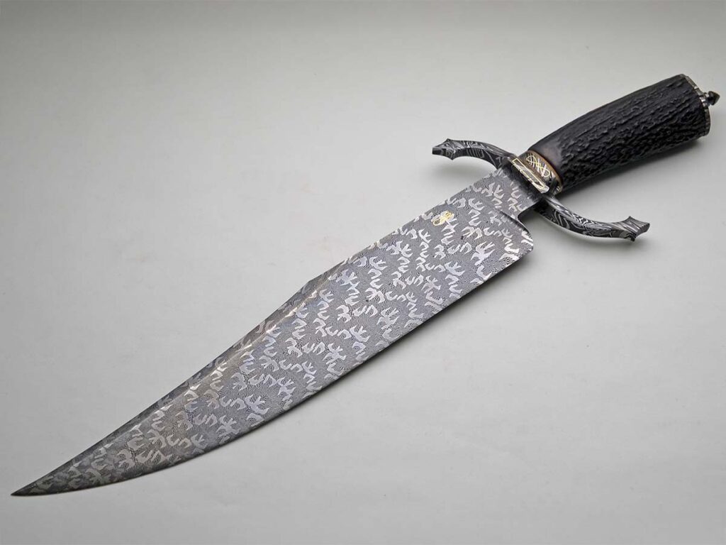 “Bowie would carry something like one of the CAS knives,” purveyor/retired ABS master smith Dave Ellis said. “They’re perfectly executed with high-end materials and expert technique.” A Sobral Brothers/CAS bowie in mosaic damascus, S-guard, gold accents and stag handle applies. (Dave Ellis/Exquisiteknives.com image)