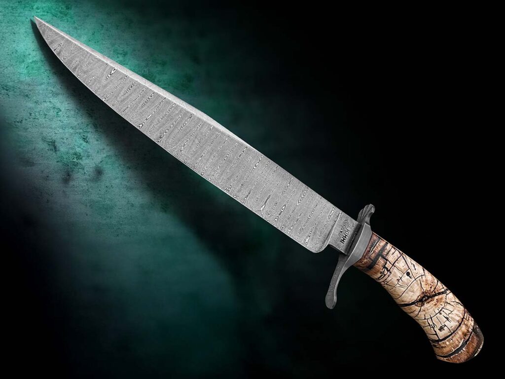 Attracted to larger bowie designs, Gene Kimmi pulls it off with a giant gem. Featuring ladder-pattern damascus—fashioned from dies he made himself—the 15.25-inch behemoth is further bespoke with a crosscut mammoth tusk handle. (Jocelyn Frasier image)