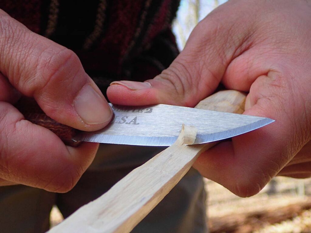 The author uses the Bear Forest Knives Simple 2 in a chest-lever grip for making camp tools.