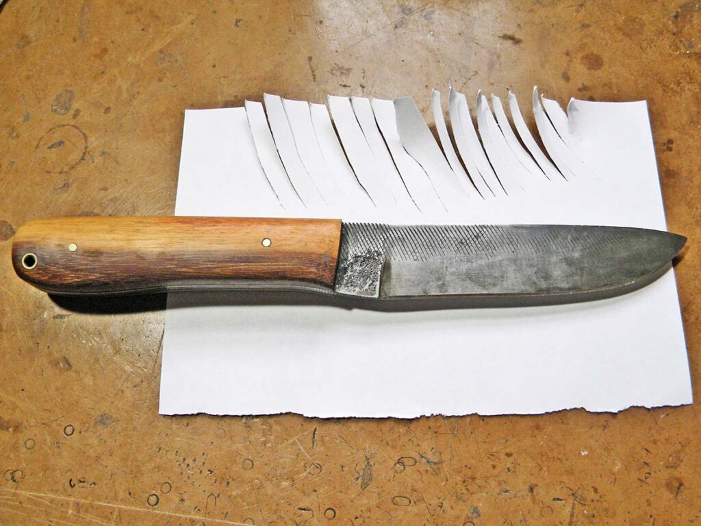 At the end of testing, the author returned to slicing the copy paper to check for edge snags or chips. The Bushcrafter sliced for the win. There was no edge damage. Heat treatment: spot on.
