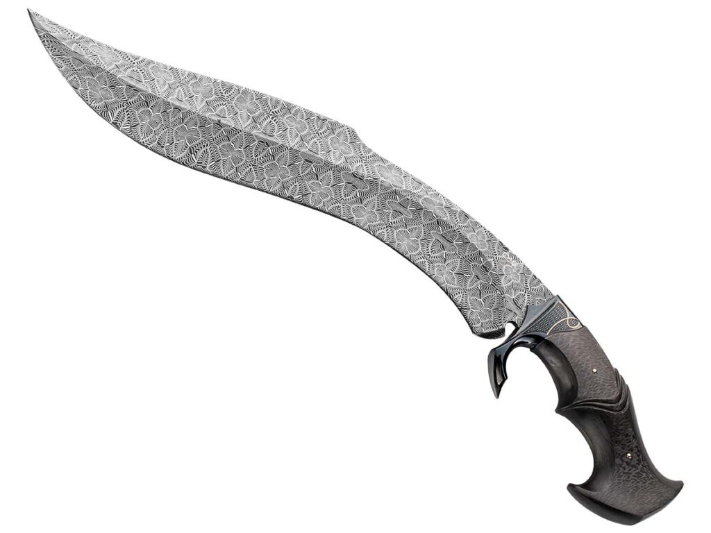 TCAS Knives nabbed Best Damascus at BLADE Show 2023 for a kukri in a mosaic damascus pattern of 1095 carbon and 15N20 nickel-alloy steels Steve Schwarzer described as being very controlled and that required precision forging. Inset are Claudio and Ariel Sobral of CAS. (Jocelyn Frasier knife image)