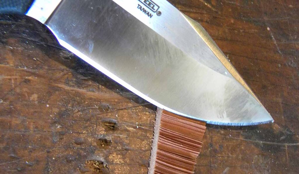 Cold Steel knife cutting leather