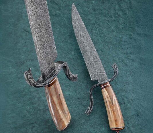 The author met Steve Randall and his wife, Alison, at the 2015 BLADE Show. Today, Steve’s table is always the author’s first BLADE Show stop. Steve’s Tumbleweed Damascus Fighter sports an 8.5-inch blade of spellbinding mosaic damascus and an ancient walrus ivory handle. Guard: damascus. Ferrule and buttcap: nitre blued to a rich brown color. Overall length: 13 inches. Steve’s price for a similar knife: $3,200. (SharpByCoop image)