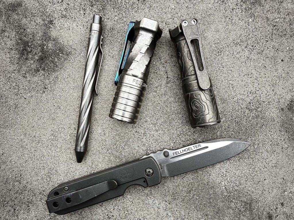 The author contends, pocket dumps are a social ritual among collectors at shows, showing off their high-end, custom EDC. For a Fellhoelter Toolwerx enthusiast, this dump would be a treasure trove, with the concern’s TiCickler pen, FTD flashlight (Ti), Triple Aught Design FTD collab light and FRH knife.