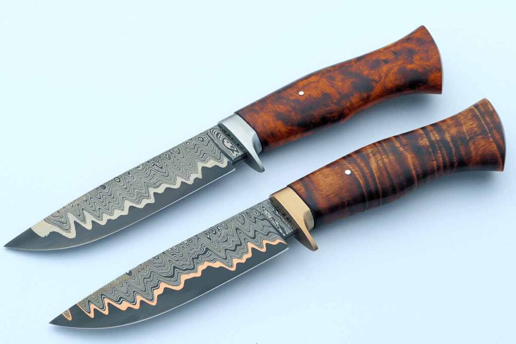 Dan Lewis' dmascus and copper san-mai hunters, both striking outdoor options.