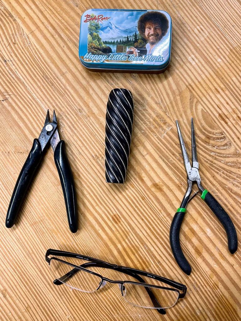 Don’t forget your essential tools—including your Bob Ross Happy Little Tree Mints.