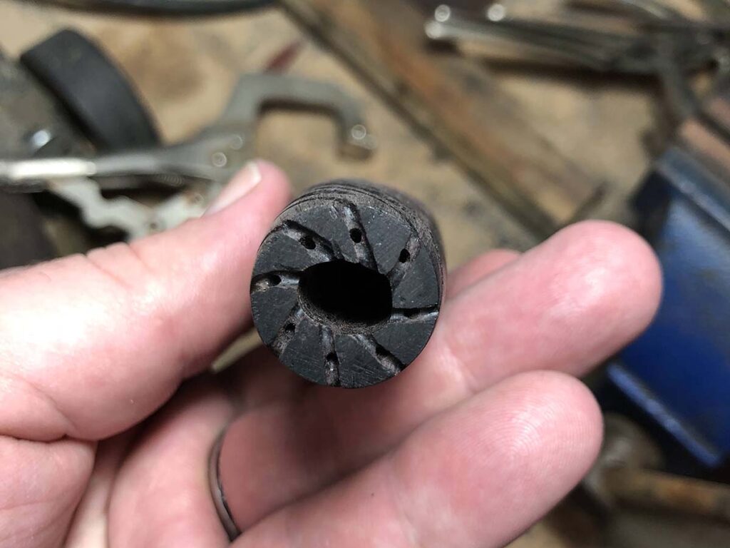 Drill diagonal holes inside your groove, starting halfway between the broached hole and the edge.