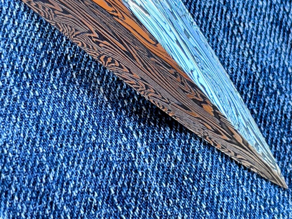 Forged for Continuity. An intricately patterned damascus dagger by Gregory Verizhnikov shows why sometimes forging is worth it—forging through the tip preserves the pattern’s flow.