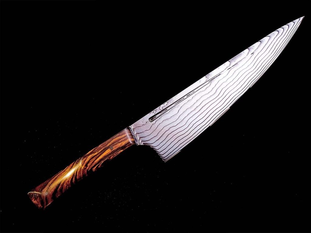 Damasteel has developed the capability to produce stainless damascus in sheets, not just bars. The sheet steel pattern is called “Drakkar,” the old Norse word for the dragon-shaped Viking longboats, and is used here on a chef’s knife by a local Swedish cutler.