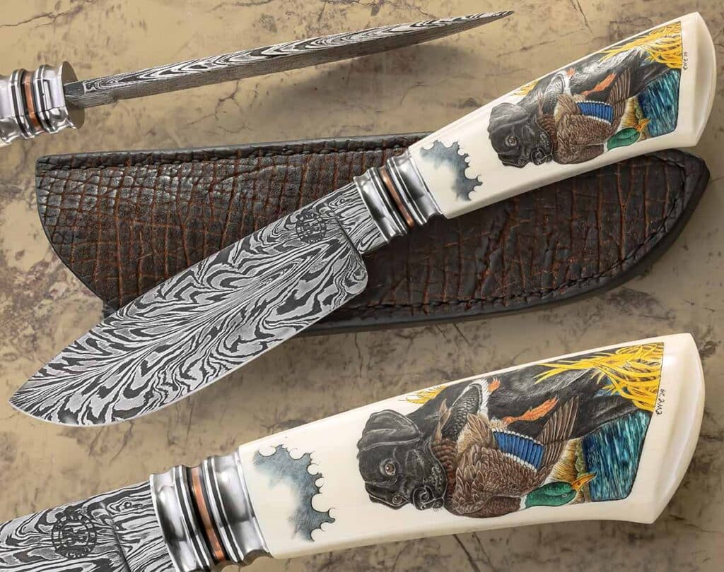 For the blade of his fancy hunter, Blake Nichols employs a damascus of 1095 carbon and 15N20 nickel alloy steels forged by Greg Shahan. Blake said he is comfortable with the heat-treating process and also feels like he gets the performance he wants from the combination of the two component steels. Overall length: 10 inches. The scrimshaw is by Charles W. Conner III. (SharpByCoop image)