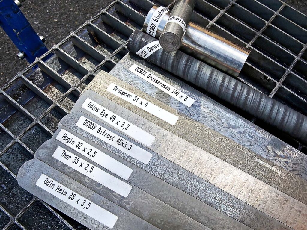DS93X steel—fourth from bottom in bar form—is Damasteel’s standard mix, “combining good performance with good looks.” “For us it’s more about expanding the patterns than about trying new steel combos,” noted Per Jarbelius. The other patterns in bar form are representative examples of what you can expect from the Swedish steel maker.