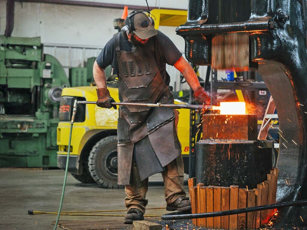 Baker Forge & Tool’s Will Spears forges a billet of stainless damascus on the Chambersburg high-frame power hammer at Baker. Built in 1946, the power hammer has a 750-pound ram and weighs just shy of 11 tons. “It took us 14 months to install,” Coy Baker laughed. “The foundation for it is over 12 feet deep.”