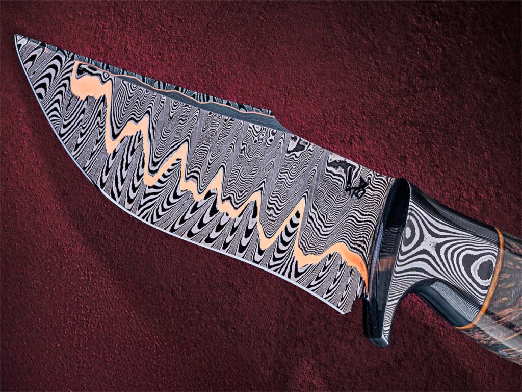 Baker Forge & Tool has been experimenting with Apex Ultra as a core steel for copper san-mai. This integral fighter by Greyson Weltyk features Baker copper damascus for its recurve harpoon blade. (Bakerforge.com image)