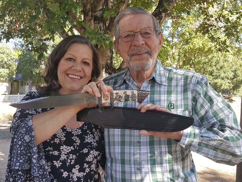 Scrimshander Linda Karst Stone (left) and sheath maker Paul Long (right) hold the completed project. (knife image by Whetstone Studio)
