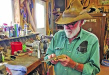 Ed Fowler cradles one of his trademark sheep-horn handle knives at his shop bench at his ranch in Riverton, Wyoming.
