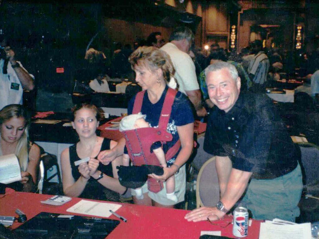 From left at right are Megan, Rachael, Mary with Lucas asleep in the baby carrier and Ernest. Among those in the front of the table at left are knife purveyors Bob and Linda Neal, Karen and Jay Sadow and BLADE Magazine Cutlery Hall-of-Fame® member Dan Delavan.