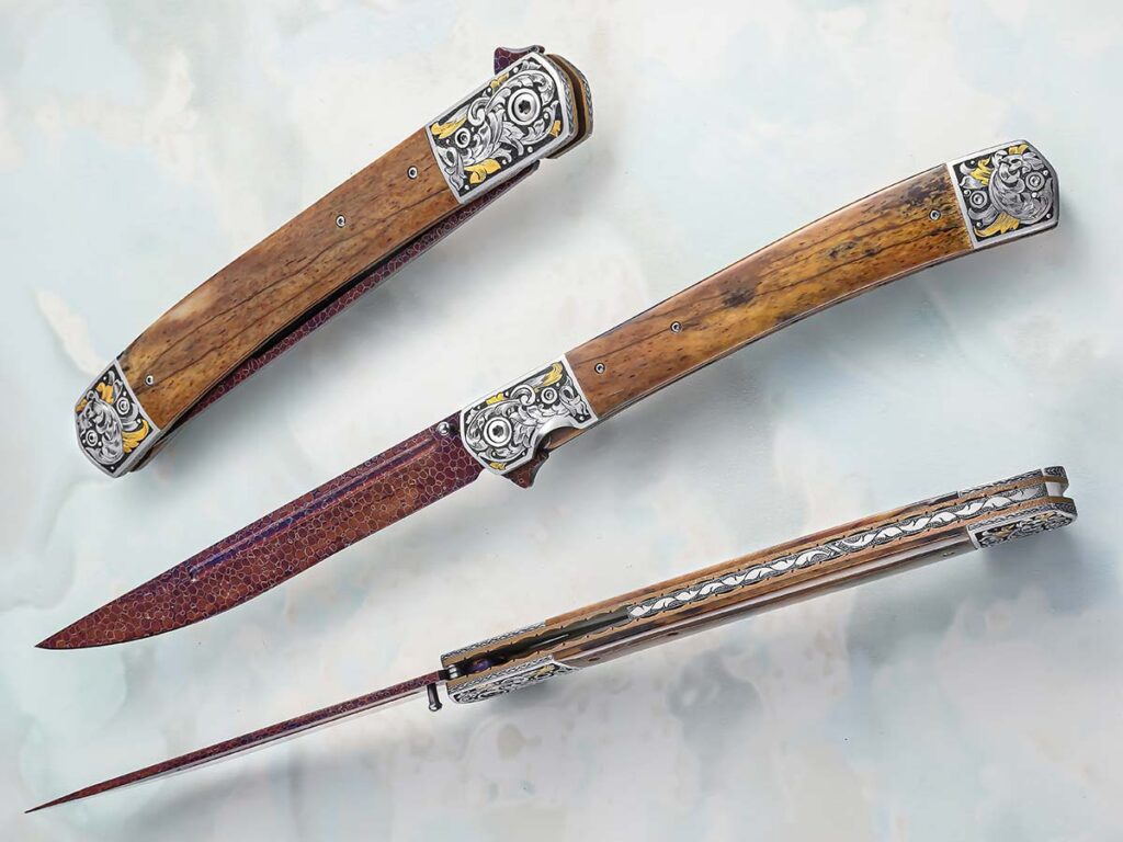 Robert Champion spends plenty of time perfecting the placement of the deployment tab. On his Dark Wind, he employs a low-profile tab to avoid pinching when the blade is deployed. Also noteworthy on this knife, the knock-out engraving by Dale Bass that takes the work to another level. (SharpByCoop image)