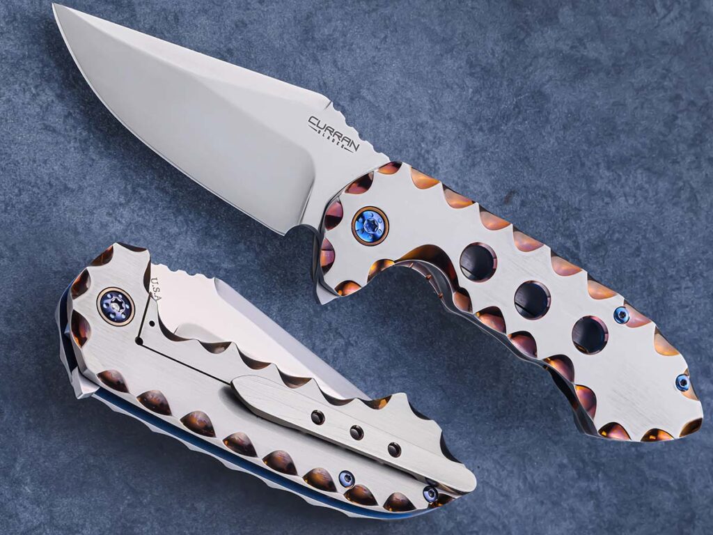 John Curran has focused much of his work on flipper folders and his experience in this design shows in his Alpha 3. Clean and complex, the knife pairs a titanium handle with an Elmax steel blade, featuring caged bearings for absolute, buttery-smooth deployment. (SharpByCoop image)