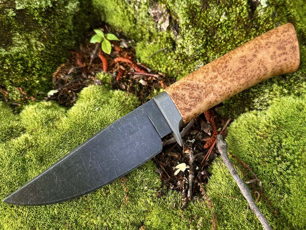 A 4-inch blade of 8670 carbon steel in a stonewashed finish and a maple burl handle help complete the Wagu Cattleman by Guild probationary member Chip Carlisle of Skjeggmenn Knives. Handle: maple burl. Overall length: 9.5 inches. Blade grind: full-height flat. Edge thickness: .020 inch. His price for a similar knife: $400.