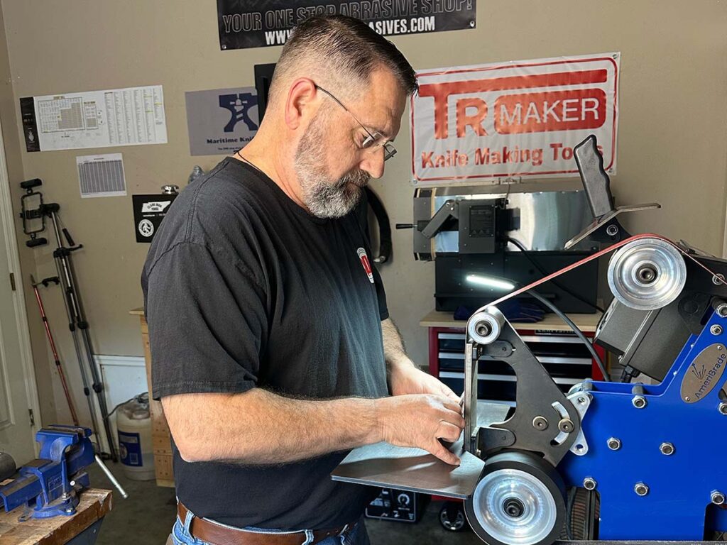 Chip Carlisle applies a flat blade grind using his belt grinder.