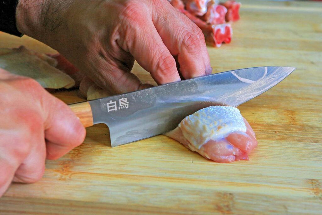 Fox gyuto effortlessly cuts chicken thighs