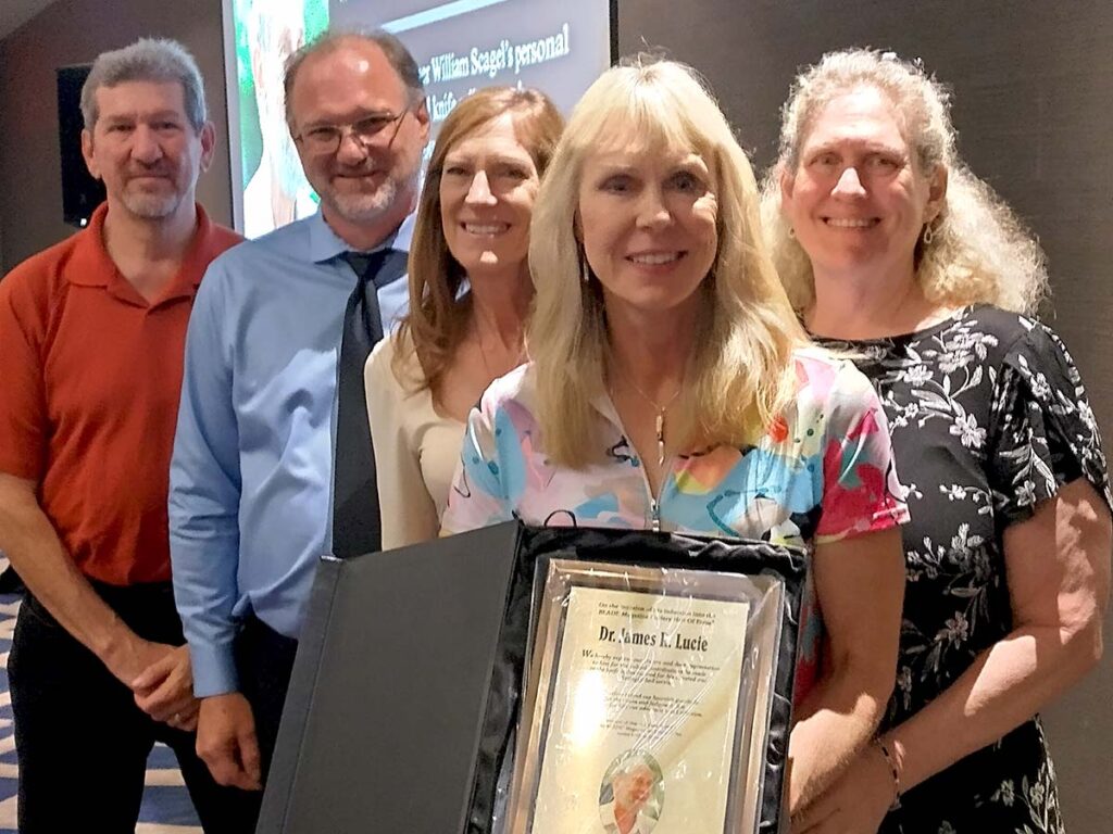 Stephanie Lucie inducted her father, Dr. Jim Lucie, with family and friends as special guests. From left: the inductee’s nephew, Chris Lucie; ABS master smith Kevin Cashen; and the inductee’s daughters, Robin Lucie, Stephanie Lucie and Pam Lafrance.