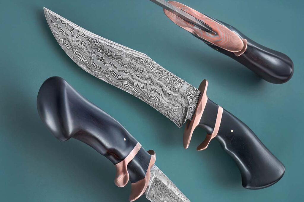 Built for an Army buddy, Justin Harrington’s superb sub-hilt fighter incorporates a masterful balance of random pattern damascus, mokumé gané and African blackwood. Blade and overall lengths: 8.5 and 13.5 inches. (SharpByCoop knife image)