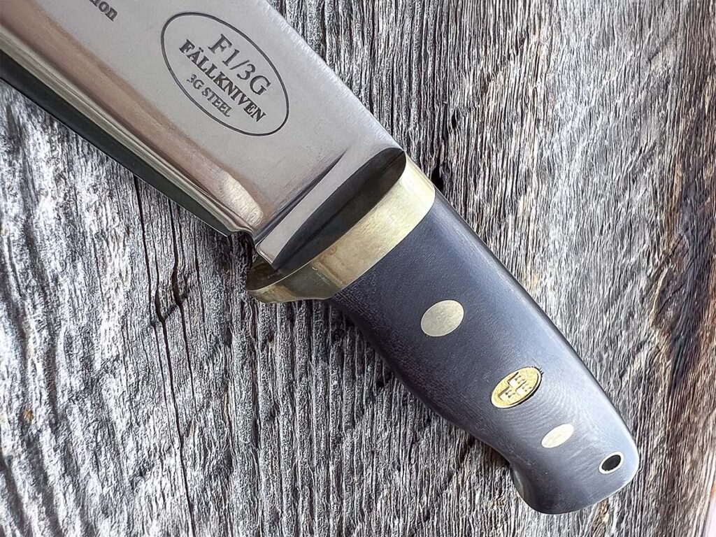 Maroon Micarta® is the handle material of choice for the Fallkniven F1L3GMM fixed hunter. It is pinned to the tang using Corby rivets.  