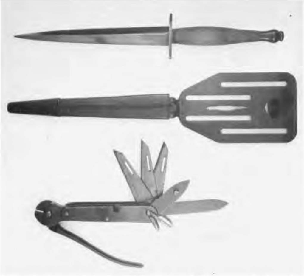 World War II OSS knives, from top: an OSS stiletto with a pancake-flapper sheath and a standard-issue OSS escape knife, completely blued and unmarked.