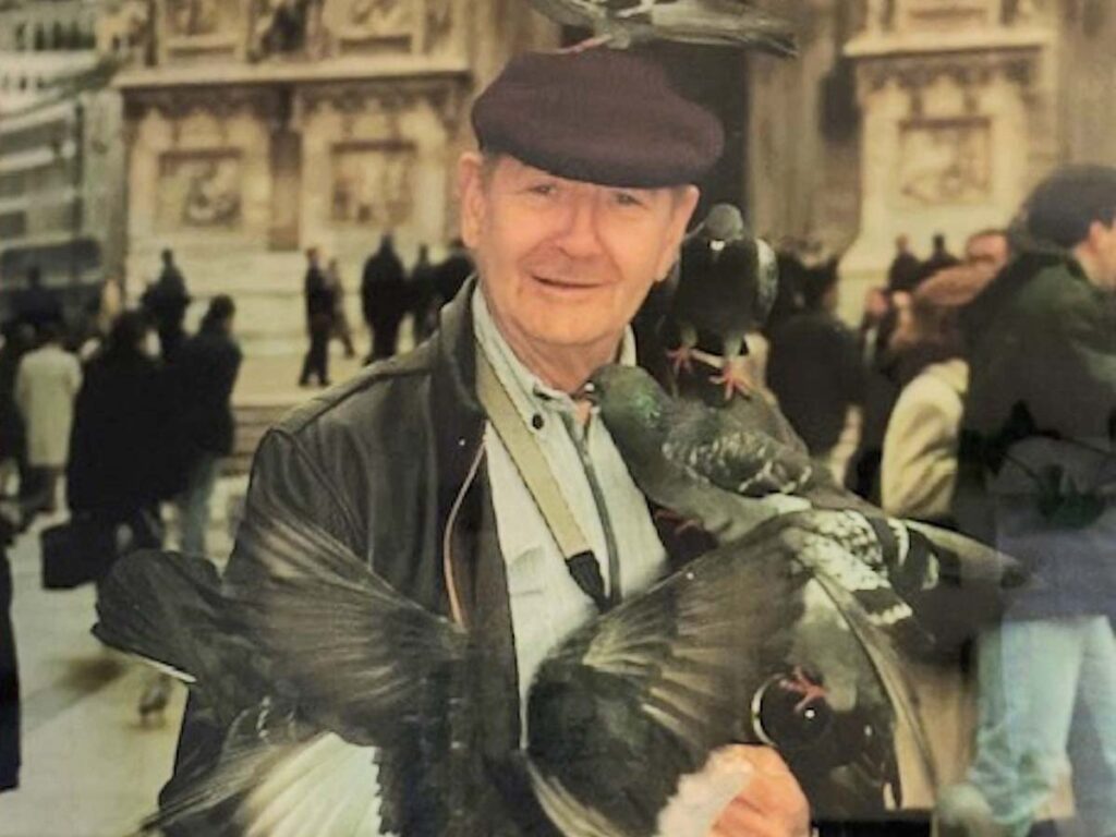 In addition to the knife her dad made for her, Robin’s other favorite keepsake is a photo of him, a joyous grin radiating from his face, as a cluster of pigeons lands on his shoulders and arms during a visit to Rome many years ago. “It’s a beautiful picture,” Robin stated, “and I look at it every day.”