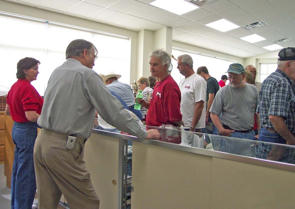 Cutlery Hall-of-Famer A.G. Russell (at far left) waits on a customer in the retail knife store inside A.G. Russell Knives.