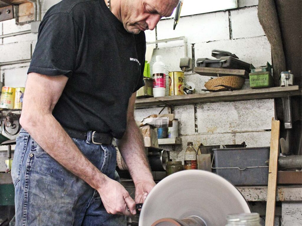 Too much heat and anything will crack—if not today, weeks or years later. Epoxies usually give way at anything over 150° F. Buffers will bring the temperature up to that point quickly, making the epoxy no more than a filler rather than bonding the materials together. Veteran French knifemaker Fred Perrin polishes a knife on an old-school buffing wheel in his shop. (image courtesy of Michael Janich)