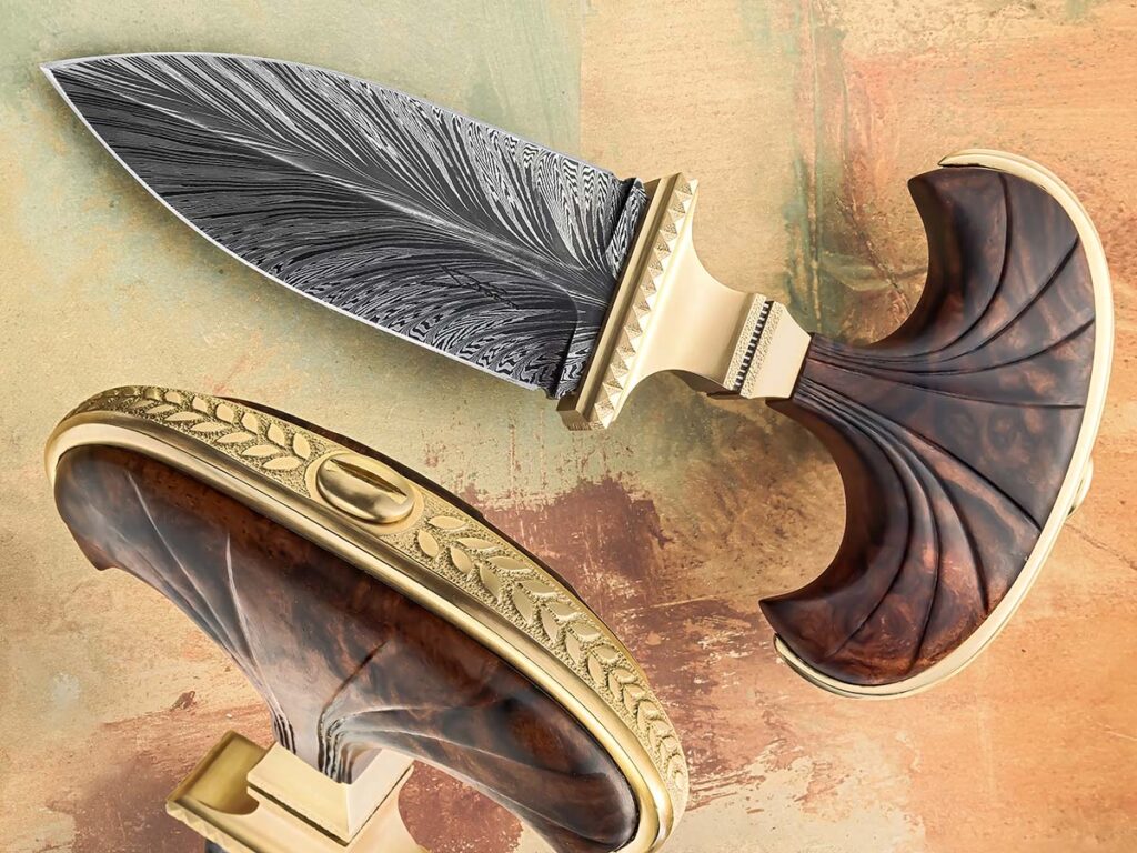 Since push daggers are illegal in Jean Pierre Potvin’s homeland of Canada, he had to come up with a clever trick to get his his Romanesque push dagger past airport security and to a buyer at a show in Las Vegas. His solution, remove the illicit handle and replace it with a toilet plunger handle. (SharpbyCoop image)
