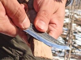 Fine-tuning a wooden wedge using the chest-lever grip with the Marttiini Arctic Bush Knife.