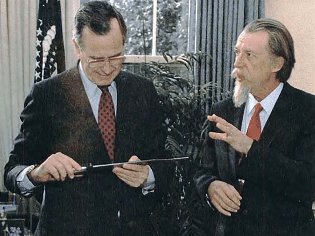 Daryl Meier’s American Flag Knife featured images of 13 flags, each with 50 stars, running the length of the blade. Meier (right) presented the knife to President George H.W. Bush (left) in the White House Oval Office in 1991.