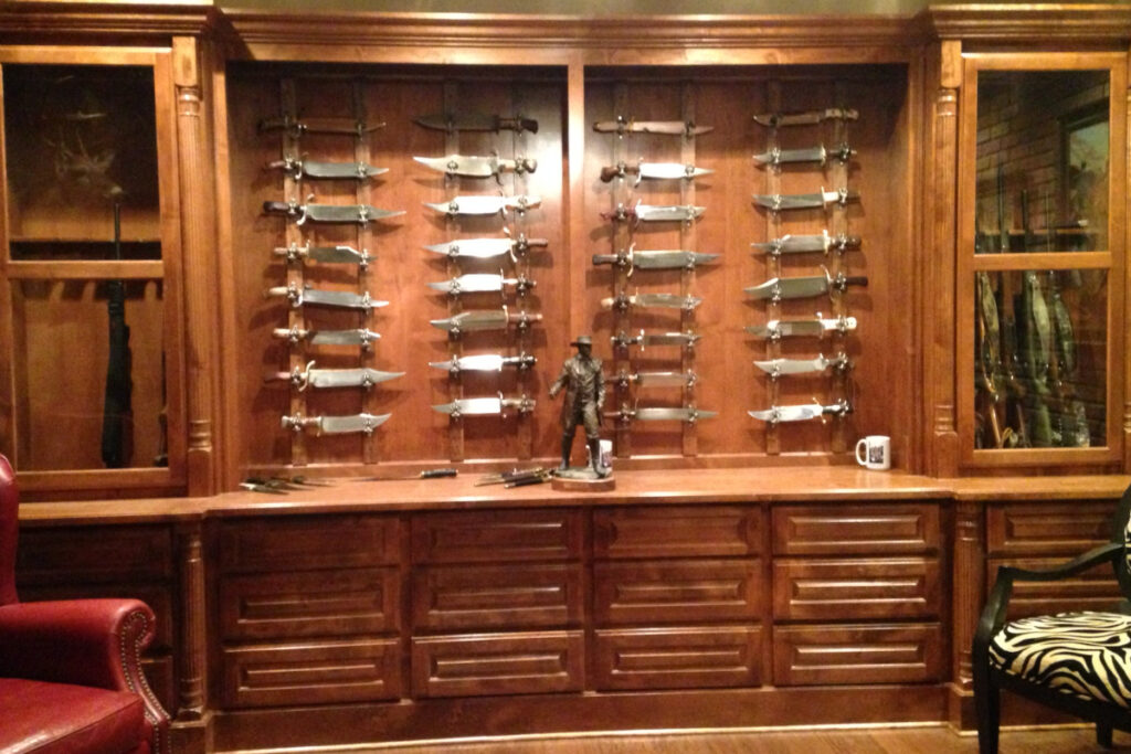 Along with studies, game rooms are also great for storing knife collections. Avid bowie collector Chris Nolen keeps his collectibles in a game room display designed by his son-in-law, replete with a statue of Jim Bowie and slide-out drawers that hold around 10 bowies each. (Chris Nolen image)