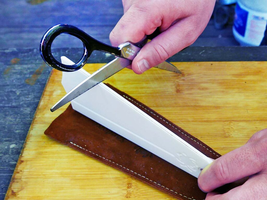Starting at the top, slide the blade’s beveled edge down the length of the Golden Stone, gradually working the edge toward the tip. Once the edge is sharp, give the opposite blade the same treatment.