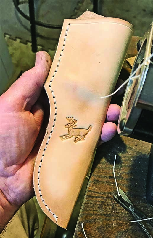  On almost every sheath, Paul Lebatard puts something in keeping with the theme of the knife, such as a small deer. “That’s a good thing about leather,” he observed. “When it is wet it can be molded and stamped, and when it dries it will hold that impression.”
