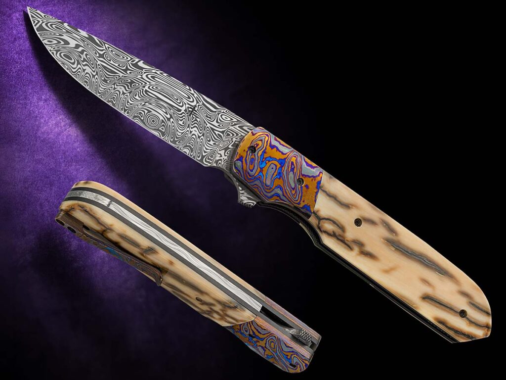 Jason Clack has a lot going on with his liner lock, from it’s 3.5-inch damasteel blade to black Timascus bolster and mammoth ivory scale. (Jocelyn Frasier image)