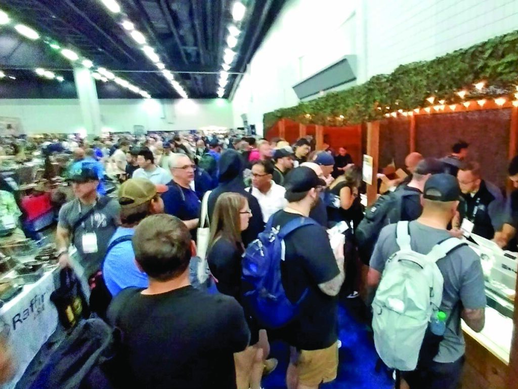 Knife fans converge on the Rick Hinderer Knives booth.