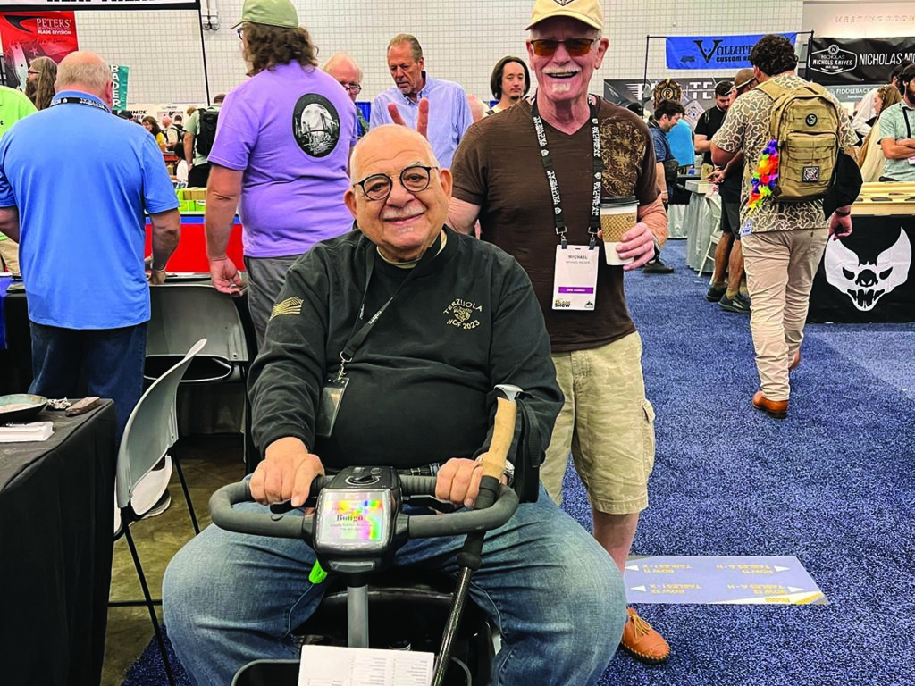 Who says BLADE Magazine Cutlery Hall-of-Fame® members can’t have fun? Michael Walker gives Bob Terzuola the rabbit-ear treatment. (Larry Hirsch image)