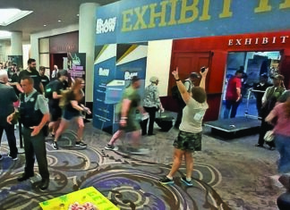 Show director Alicia Newton (center, right) gives the high sign for patrons to enter as the show opens Friday morning.